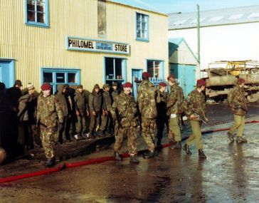 Soldiers from the Parachute Regiment guard Argentine prisoners of war during the Falklands War.