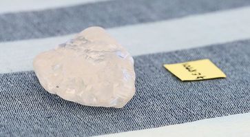 Der zuerst entdeckte 1.098,3 Karat wiegende Diamant im Größenvergleich mit einem Zettel