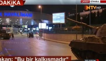 News report showing tanks approaching Istanbul's Atatürk Airport