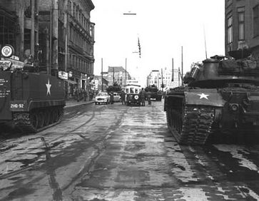 Soviet and American tanks face each other at Checkpoint Charlie, during the Berlin Crisis of 1961.