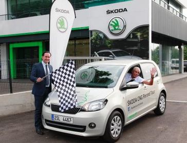 Mit einem SKODA Citigo CNG unterwegs: Gerhard Plattner (im Auto) beim Start zu seiner Rekordfahrt im italienischen Vicenza zusammen mit Donato Bochicchio, Leiter SKODA AUTO Italien. Bild: "obs/Skoda Auto Deutschland GmbH"