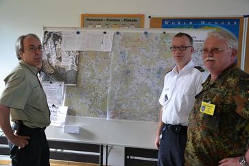 Gemeinsame Lagebesprechung an der Einsatzkarte (v. l. n. r.) Dr. Horst Marohn (Hessen-Forst, Kassel), Lars Schäfer (Kreisbrandinspektor des Landkreises Hessen, Marburg Biedenkopf) und Oberleutnant Wolfgang Heyduck (Landeskommando Hessen). Foto: Hartmut Payer