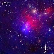 Die Aufnahme zeigt den Galaxienhaufen Abell 2744. Die Abbildung kombiniert Beobachtungen im sichtbaren Licht mit den rötlich dargestellten Beobachtungen des Röntgensatelliten Chandra und den bläulich eingefärbten Wolken Dunkler Materie. Die Besonderheiten dieses Systems werden hierbei gut sichtbar, zum Beispiel ein Klumpen Dunkler Materie ohne jegliche Sterne oder Gas (nordwestlich) sowie ein Klumpen von Galaxien und Dunkler Materie, aber ohne Gas (westlich). Die Skala gibt die Entfernung von 250.000 Parsec an, was etwa dem neunfachen Durchmesser des sichtbaren Teils unserer Milchstraße entspricht. In der Astronomie sind die Richtungen Osten und Westen „vertauscht“, wie dies in den Richtungsanzeigen unten rechts im Bild deutlich wird. Bildquelle: NASA, ESA, ESO, CXC, J. Merten (Heidelberg/Bologna) & D. Coe (STScI)