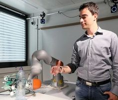 Testlauf: Roboterhand beim Ergreifen einer Flasche.