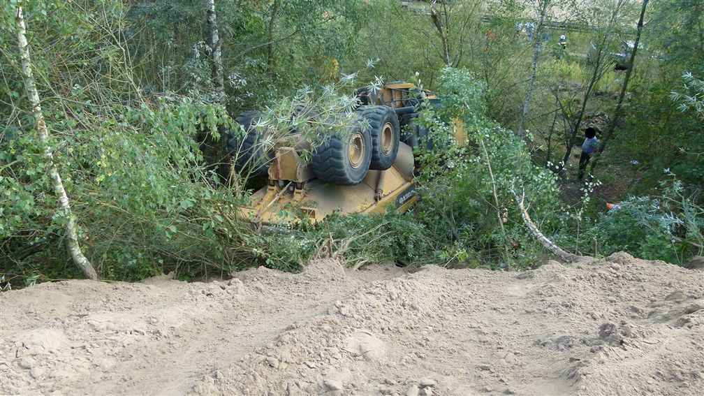 Das schwere Arbeitsgerät rutscht die Böschung rund 15 Meter hinab.