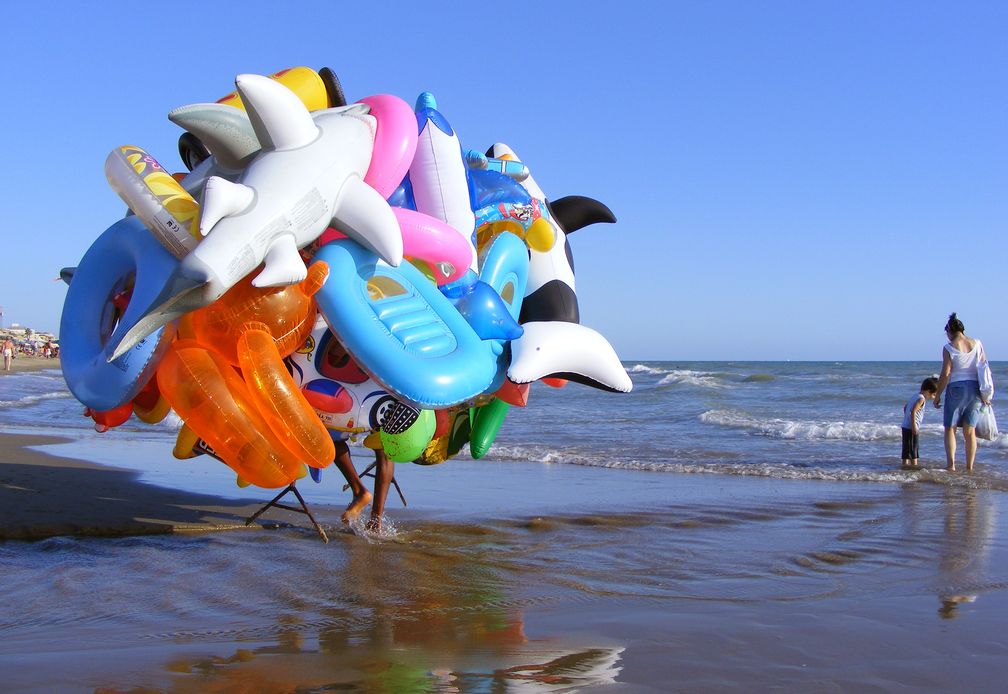 Gummitiere und andere aufblasbare Badespielzeuge eines fliegenden Händlers an einem Badestrand