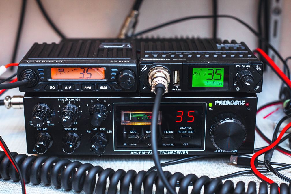 Oben zwei moderne CB-Mobilfunkgeräte, unten ein CB-Exportfunkgerät mit SSB und erhöhter Sendeleistung aus den 1980er Jahren.