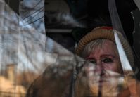 Archivbild: Eine Frau an einem zerbrochenen Fenster ihres Hauses in Donezk nach dem Beschuss durch ukrainische Streitkräfte am 10. Januar 2023 Bild: Waleri Melnikow / Sputnik