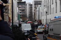 Police officers, emergency vehicles, and journalists at the scene some two hours after the shooting