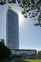 Der Post Tower mit Sockel, Sitz der Hauptverwaltung der Deutschen Post AG und Deutschen Post World Net in Bonn, entworfen vom Architekten Helmut Jahn. Bild: Thomas Robbin / wikipedia.org