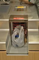 Plastiktüte: Maschine zum Eintüten in einem Kaufhaus