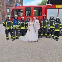 Das Brautpaar nutzte die Gelegenheit für ein ganz besonderes Erinnerungsfoto mit den Einsatzkräften Bild: Feuerwehr