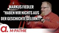 Bild: SS Video: "M-PATHIE – Zu Gast heute: Markus Fiedler – “Haben wir nichts aus der Geschichte gelernt?”" (https://tube4.apolut.net/w/fraXDFzxh8BZ3mq64AqDk4) / Eigenes Werk