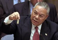 Powell holding a model vial of anthrax while giving a presentation to the United Nations Security Council in February 2003.