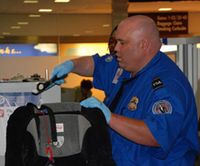 Transportation Security Administration:  TSA officer screening luggage